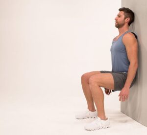 Wall sit for knee exercise